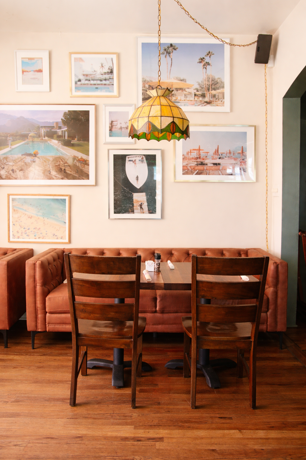 Cozy restaurant corner with coastal artwork.png