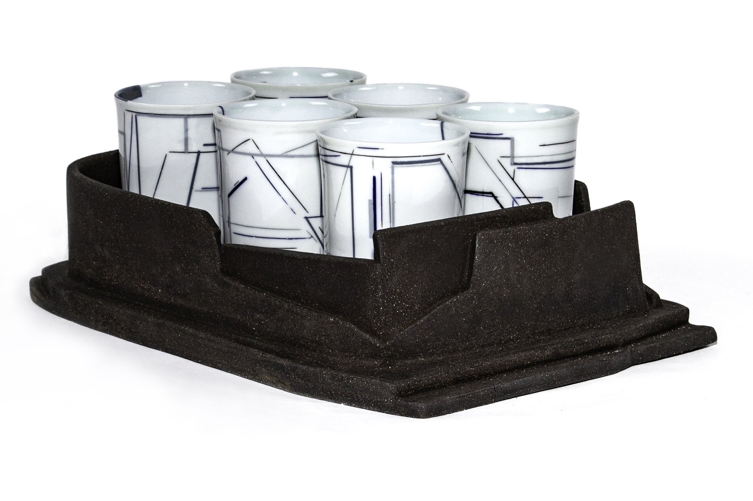 “Charcoal 6 Pack,” 2024. 5.3”H x 16.4”L x 11.5”W
Charcoal clay oxidation fired to cone 5. Porcelain casting slip. Reduction fired to cone 9.