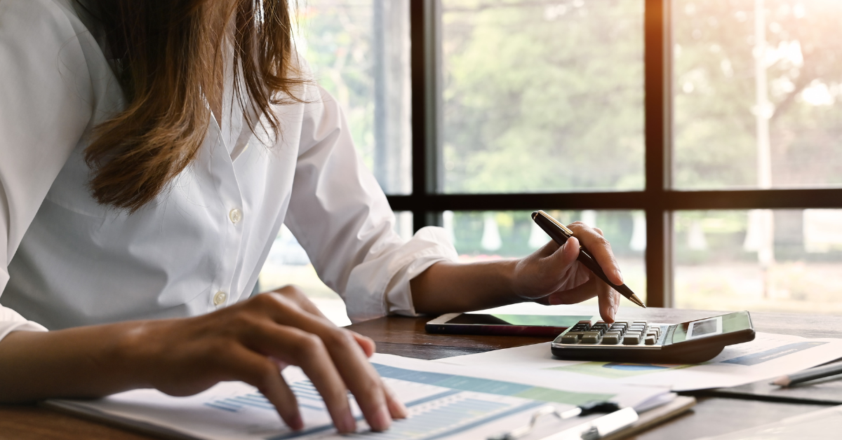 Woman sat with calculator and finance docs