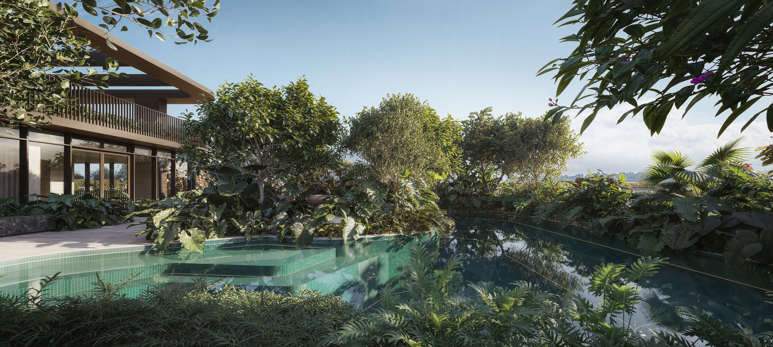 A backyard pool surrounded by lush greenery including trees and plants, with a modern house featuring a balcony and large glass doors in the background under a clear blue sky.