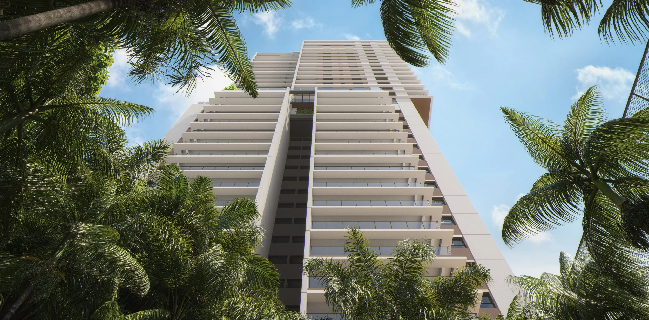 Tall modern residential building viewed from below with lush palm trees in the foreground, clear blue sky and some clouds.