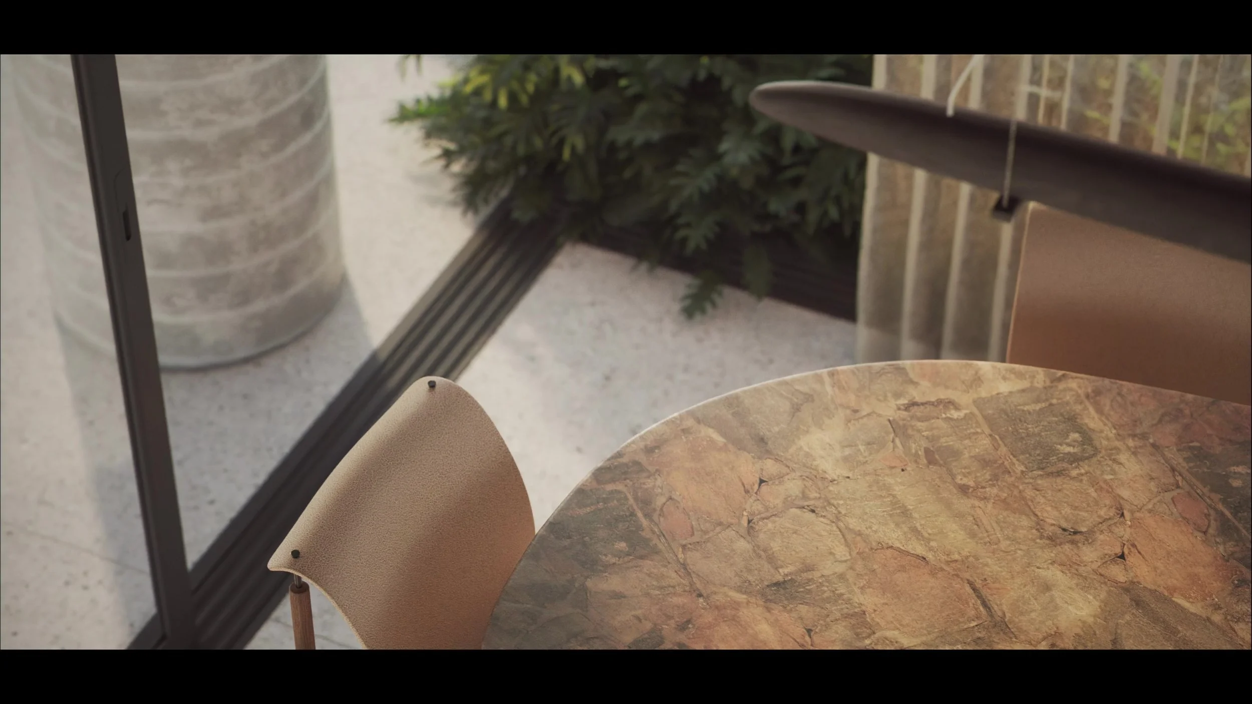 A round, marble table with earthy tones next to beige chairs, outdoor patio with plant, glass wall, and sliding door.