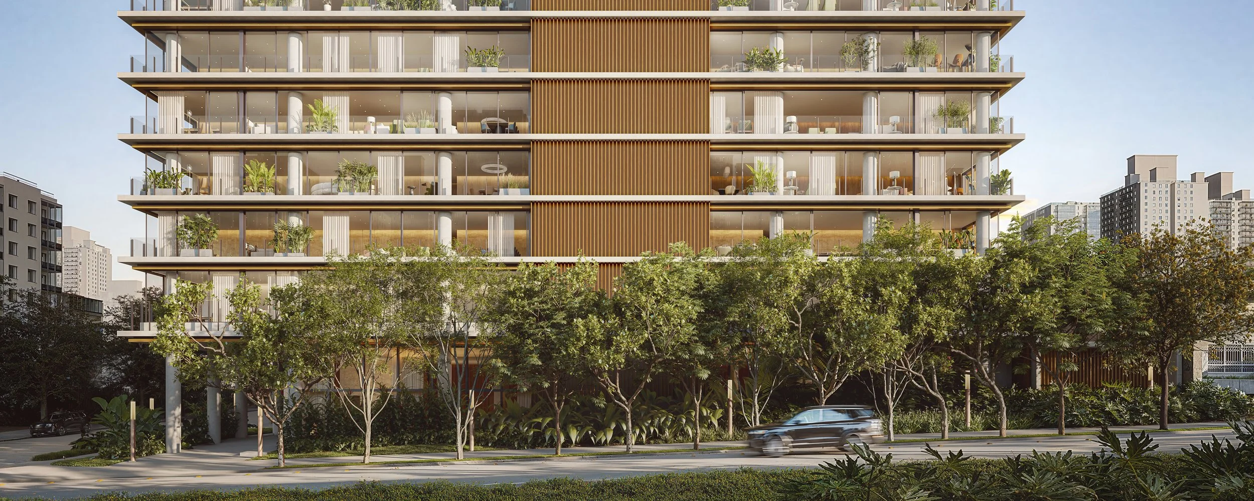 Modern multi-story building with large glass windows, wooden panel accents, and an abundance of green plants inside and outside. Trees line the street in front, with some cars passing by.