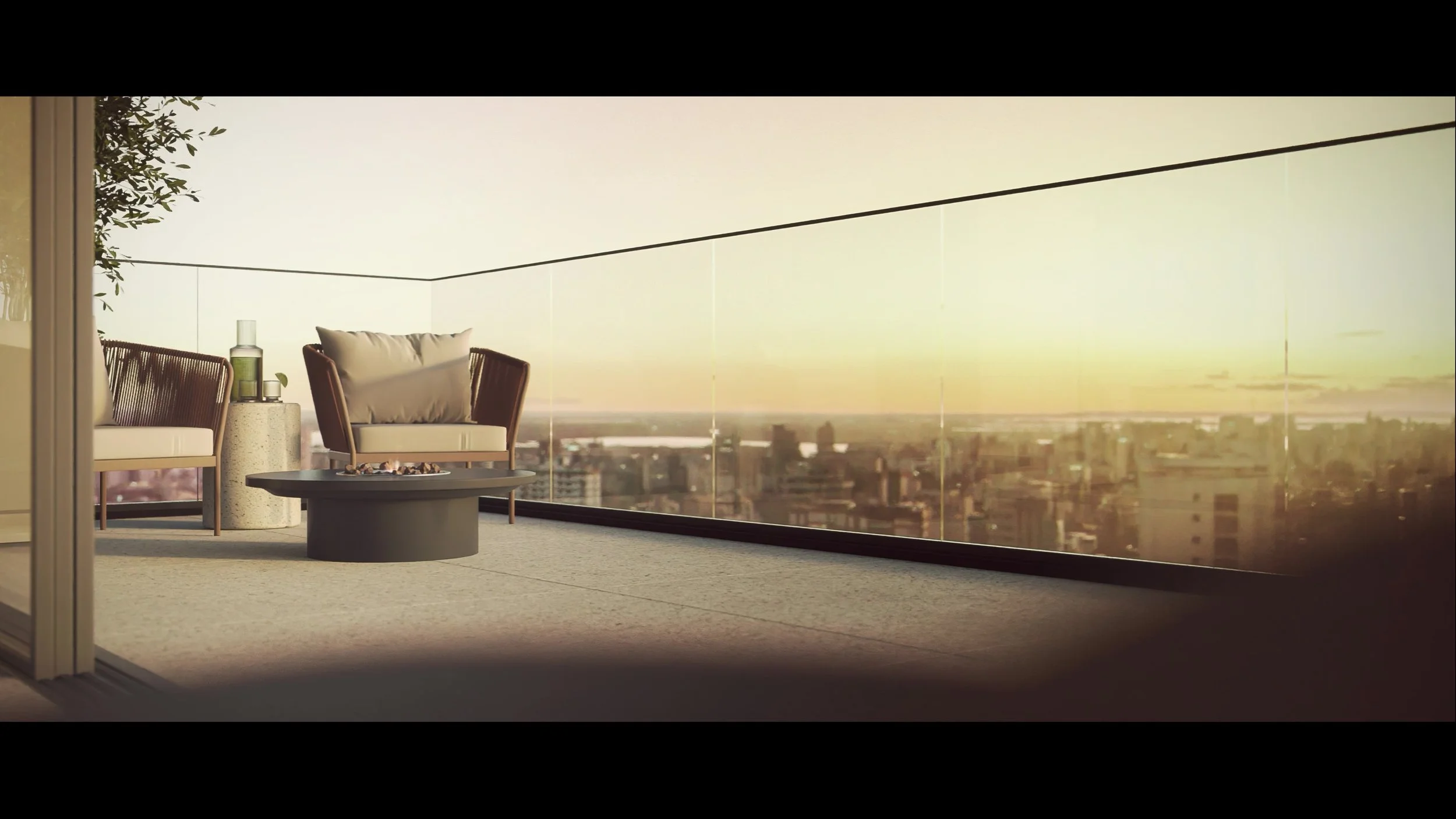 Balcony with two chairs, a small table, and a view of city skyline at sunset