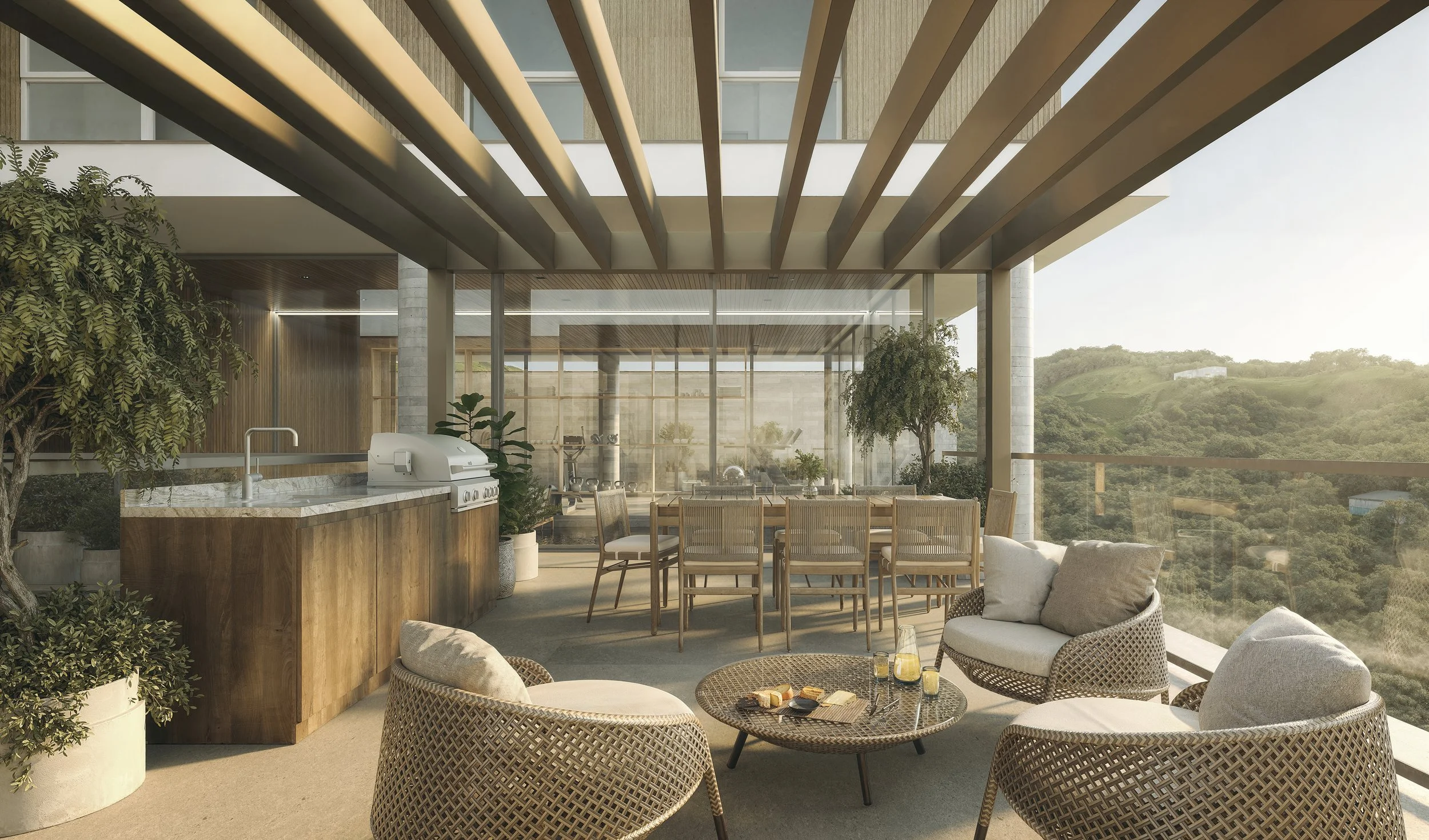 Modern balcony with a seating area, dining table, outdoor kitchen with grill, potted plants, and scenic hillside view at sunset.