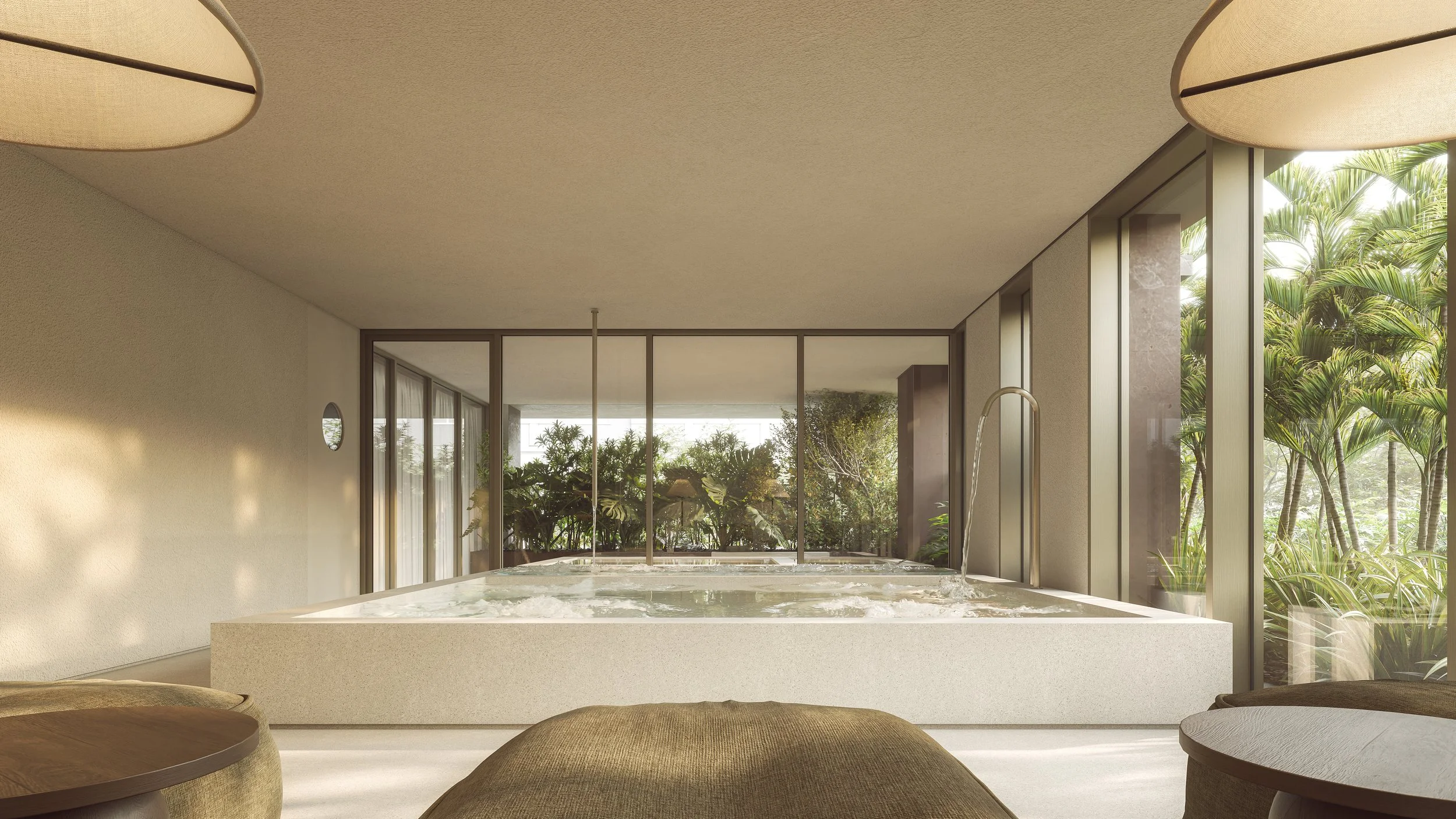 Modern indoor scene featuring a large hot tub or jacuzzi near floor-to-ceiling windows showing lush green tropical plants outdoors, with part of a round wooden table and beige cushioned seats visible in the foreground.