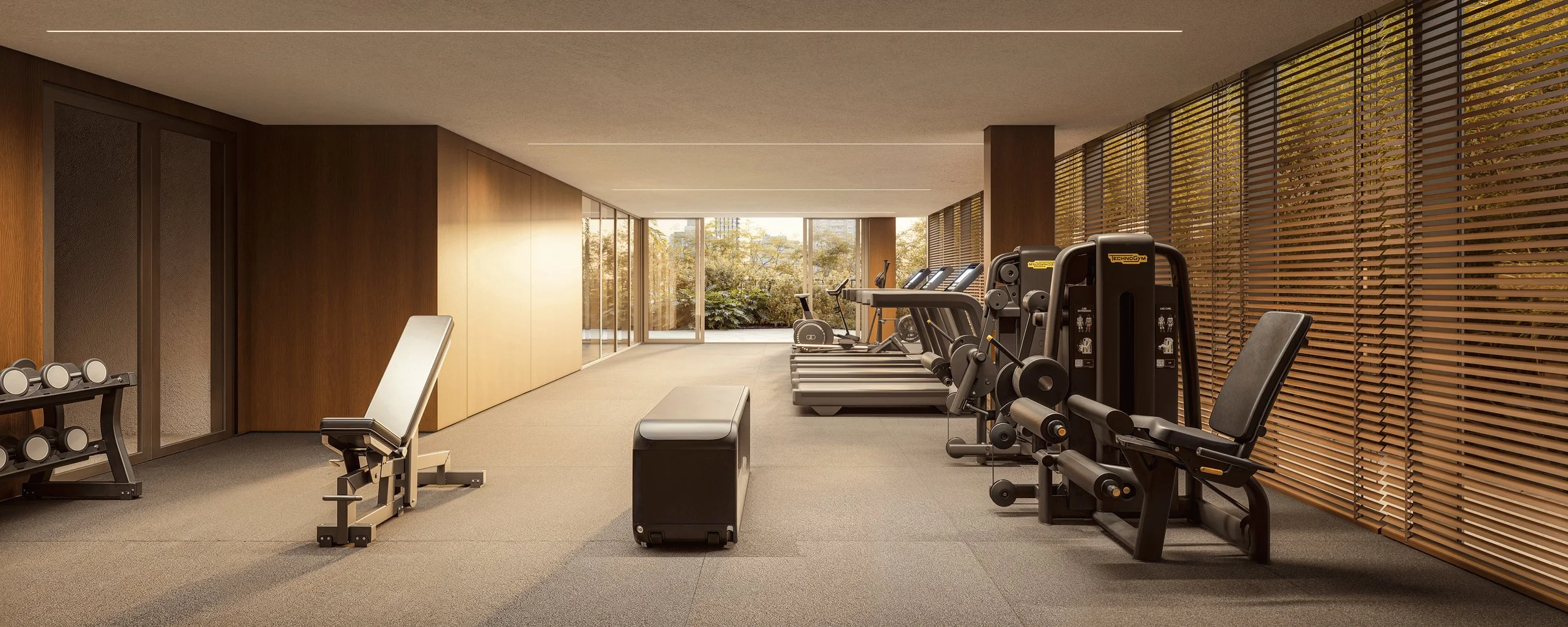 Empty modern gym with various exercise equipment including dumbbells, benches, and cardio machines, large windows with blinds, and a view of outdoor greenery.
