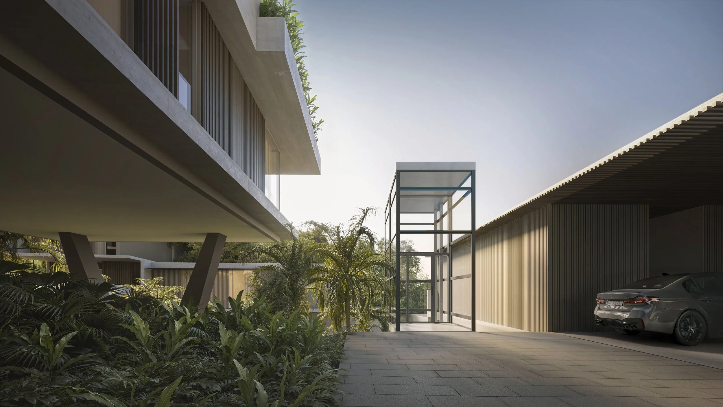 Modern building exterior with greenery, a parking area with a gray car, and a glass elevator shaft during daytime.