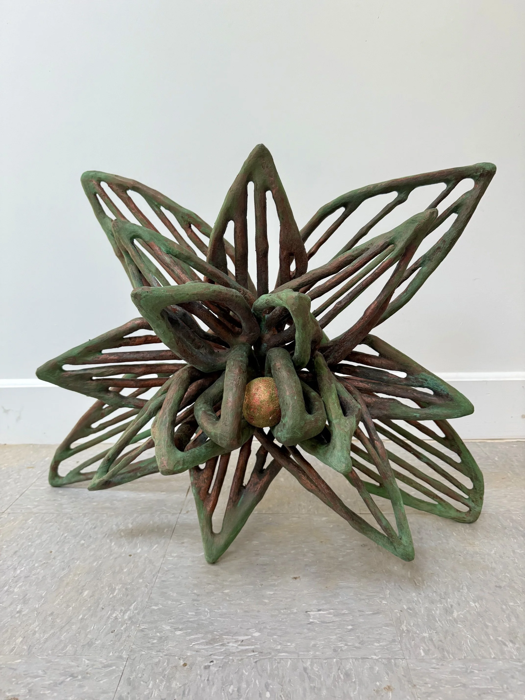 "25r/ Summer Into Spring", (full view) 2026, 204 pieces of wood, copper metal coating with green patina, paper clay with acrylic paint, and flocking.