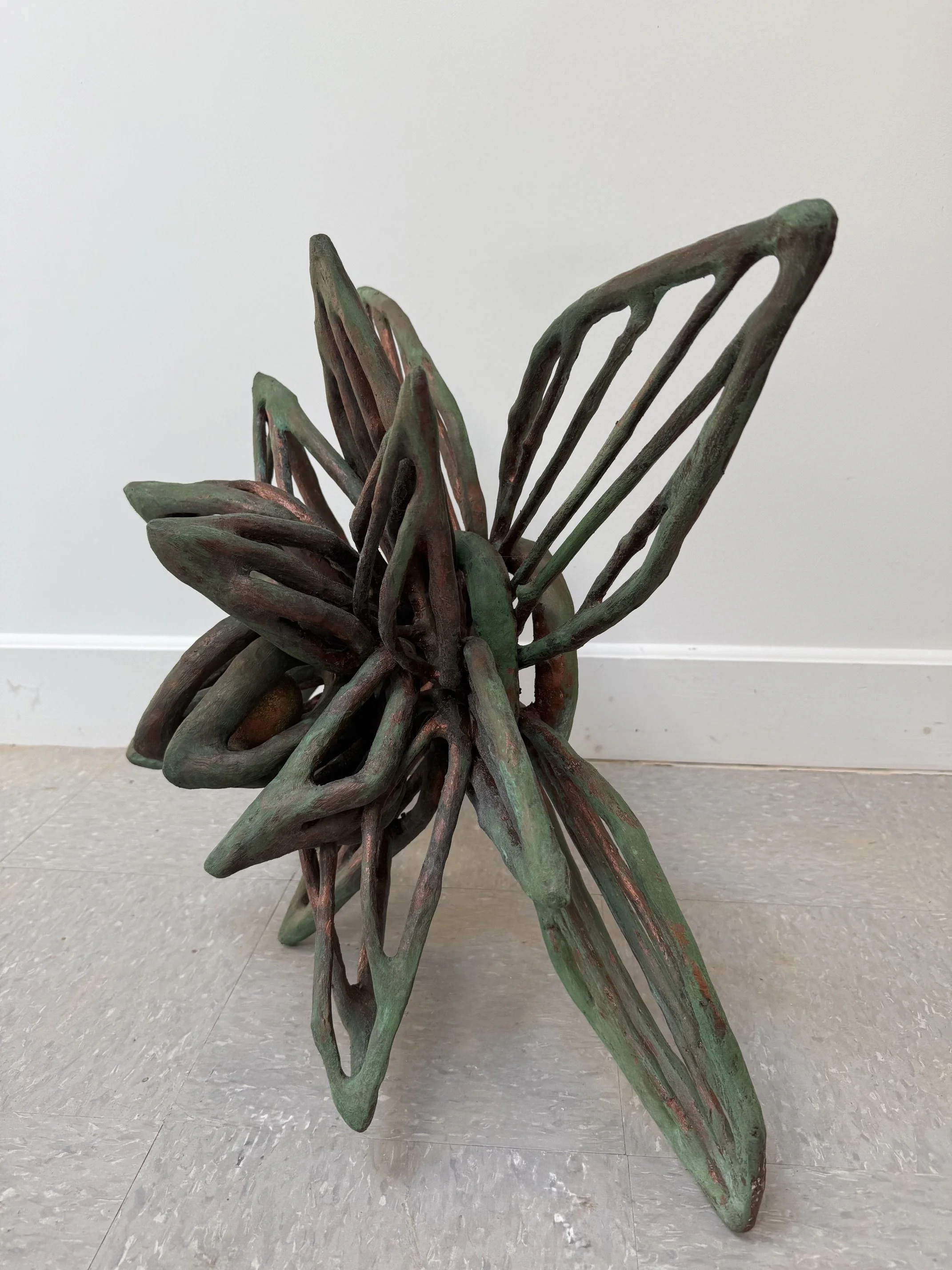 "25r/ Summer Into Spring", (side view) 2026, 204 pieces of wood, copper metal coating with green patina, paper clay with acrylic paint, and flocking.