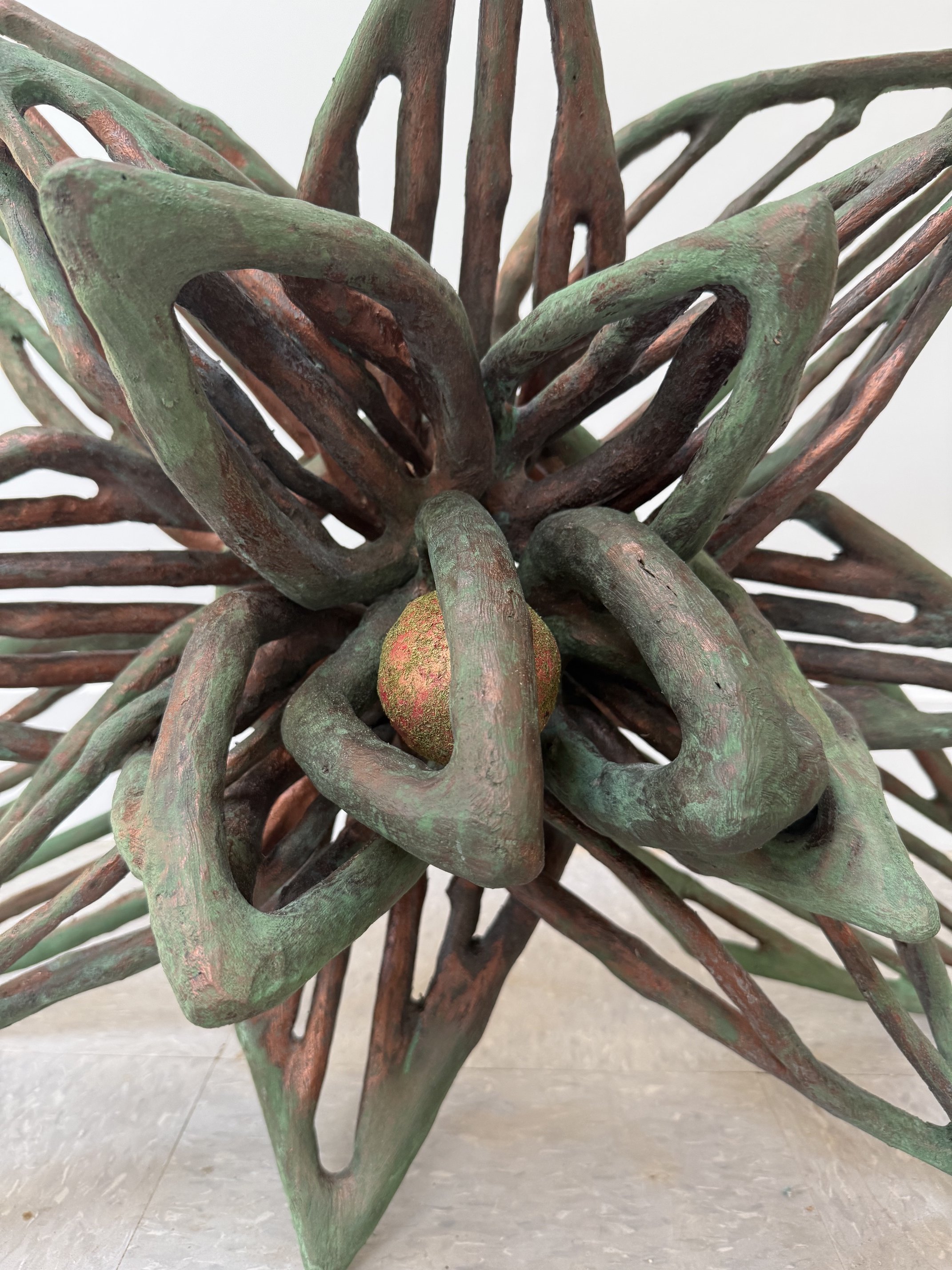 "25r/ Summer Into Spring", (close-up detail) 2026, 204 pieces of wood, copper metal coating with green patina, paper clay with acrylic paint, and flocking.