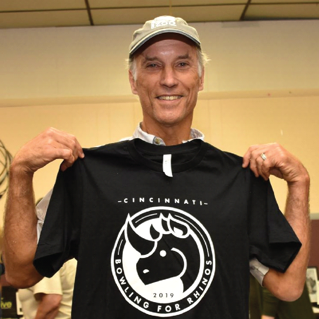 Thane Maynard holding my Bowling for Rhinos shirt design.