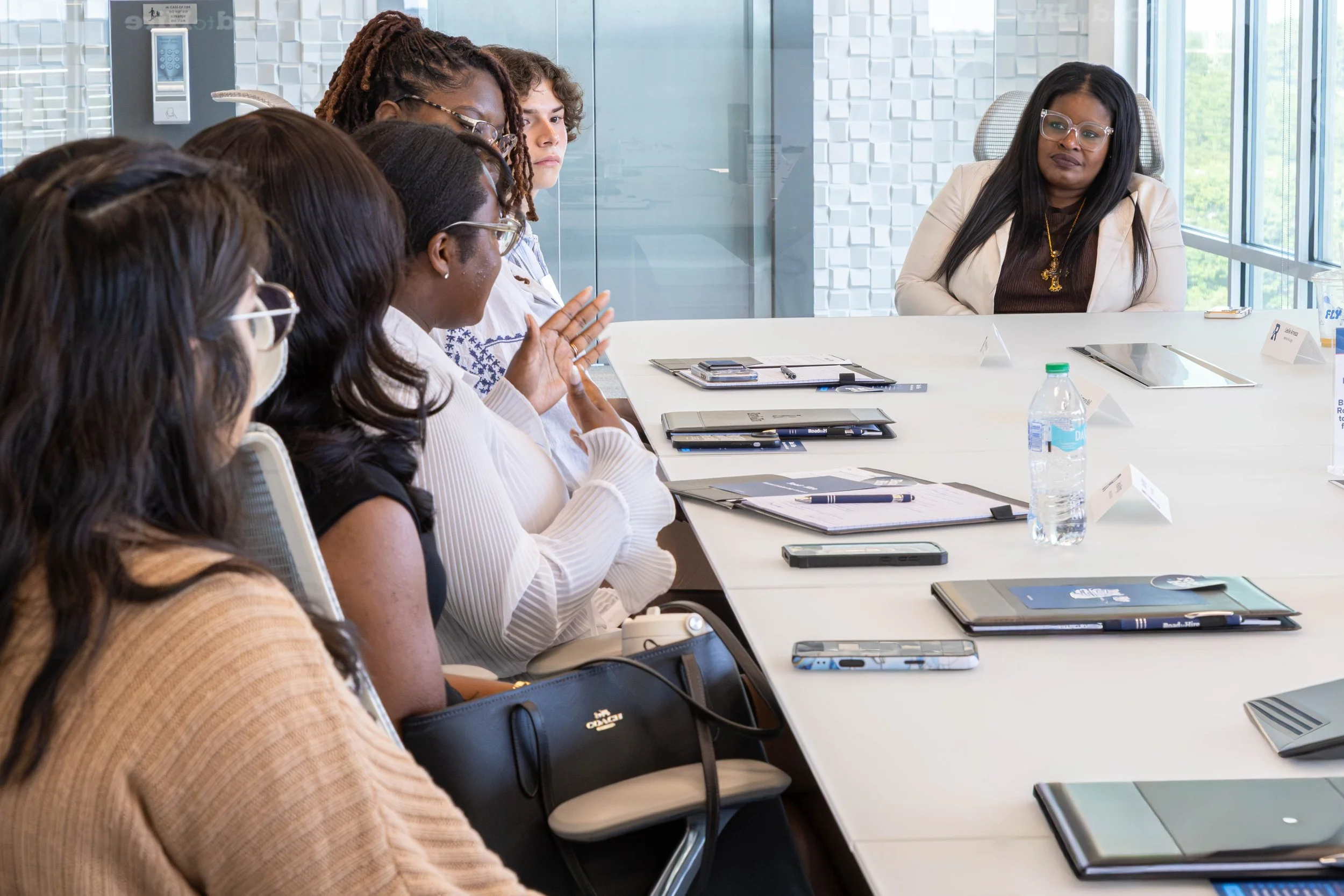 An alumna asks a question or talks while the other ALC members listen along with Dr. Monique Perry-Graves.