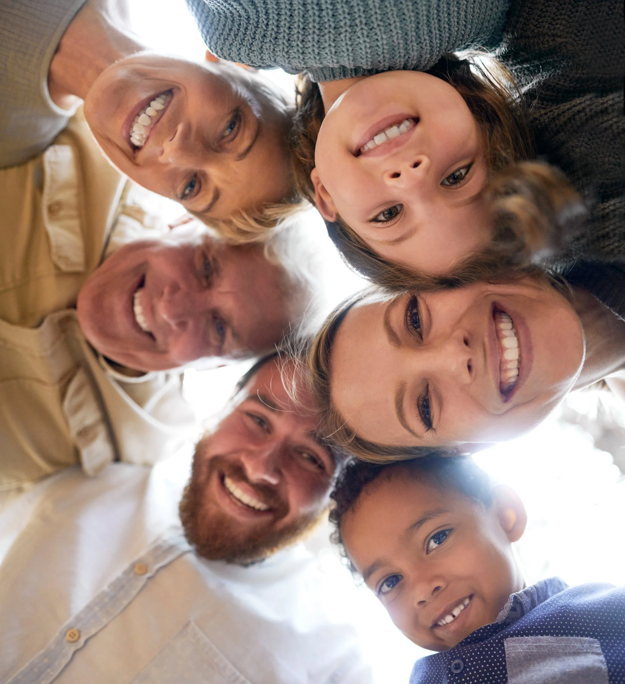 A big extended-family circle — grandparents, parents and children, foster child — supporting one another.