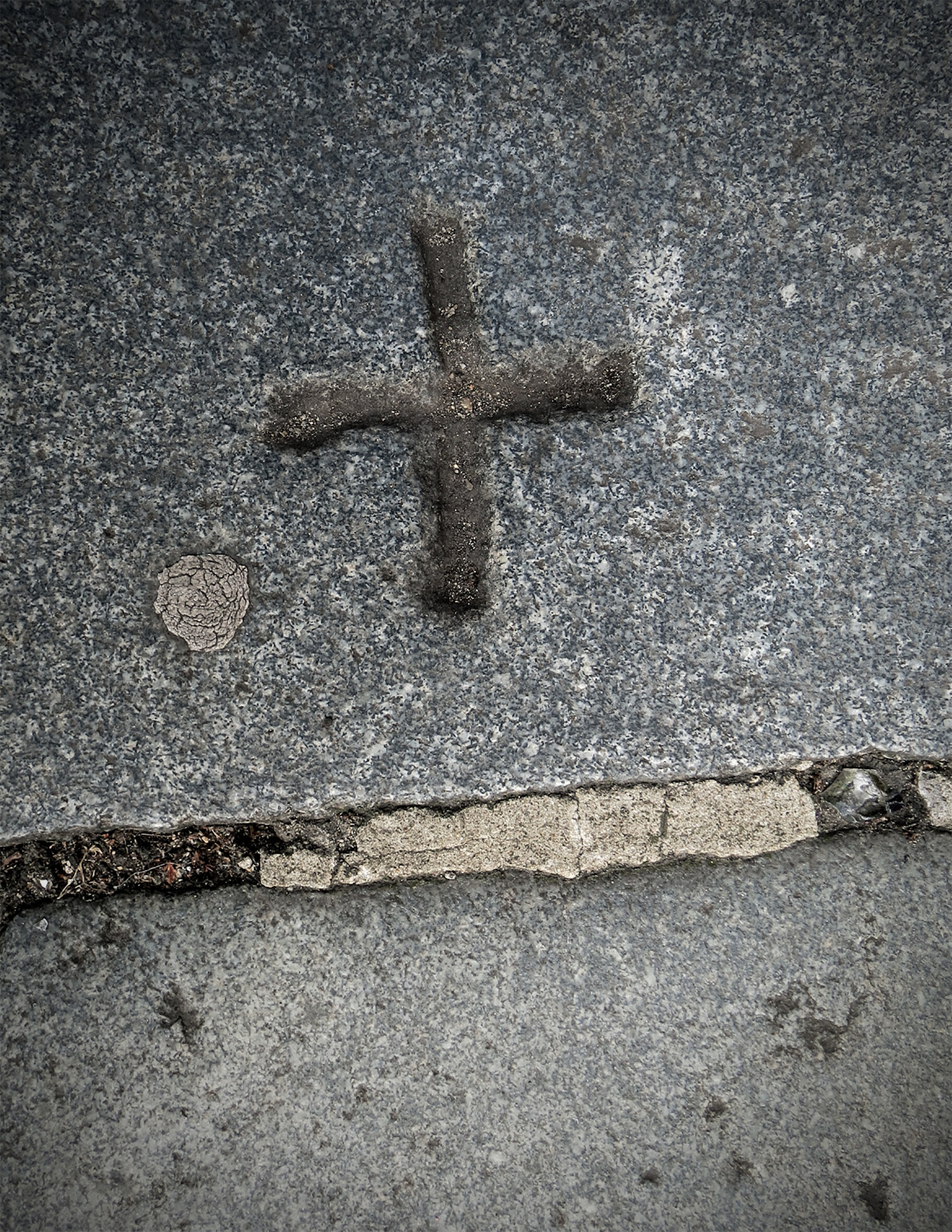 CROSS EMBEDDED IN SIDEWALK