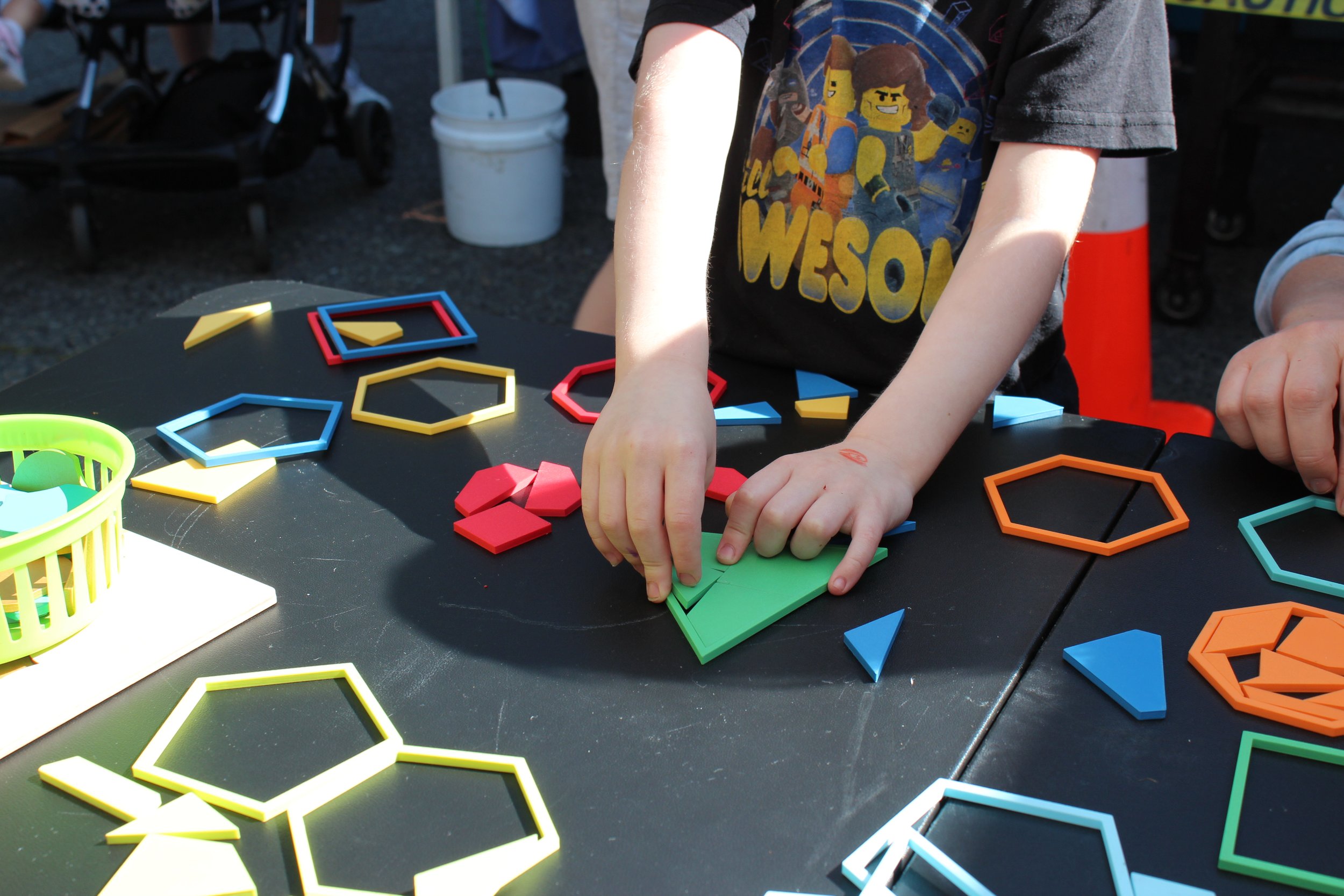 child's hands playing with polygon dissections