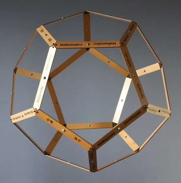 A geometric polyhedron made of wooden sticks labeled with subjects like Mathematics and Chinese, forming a dodecahedron shape.