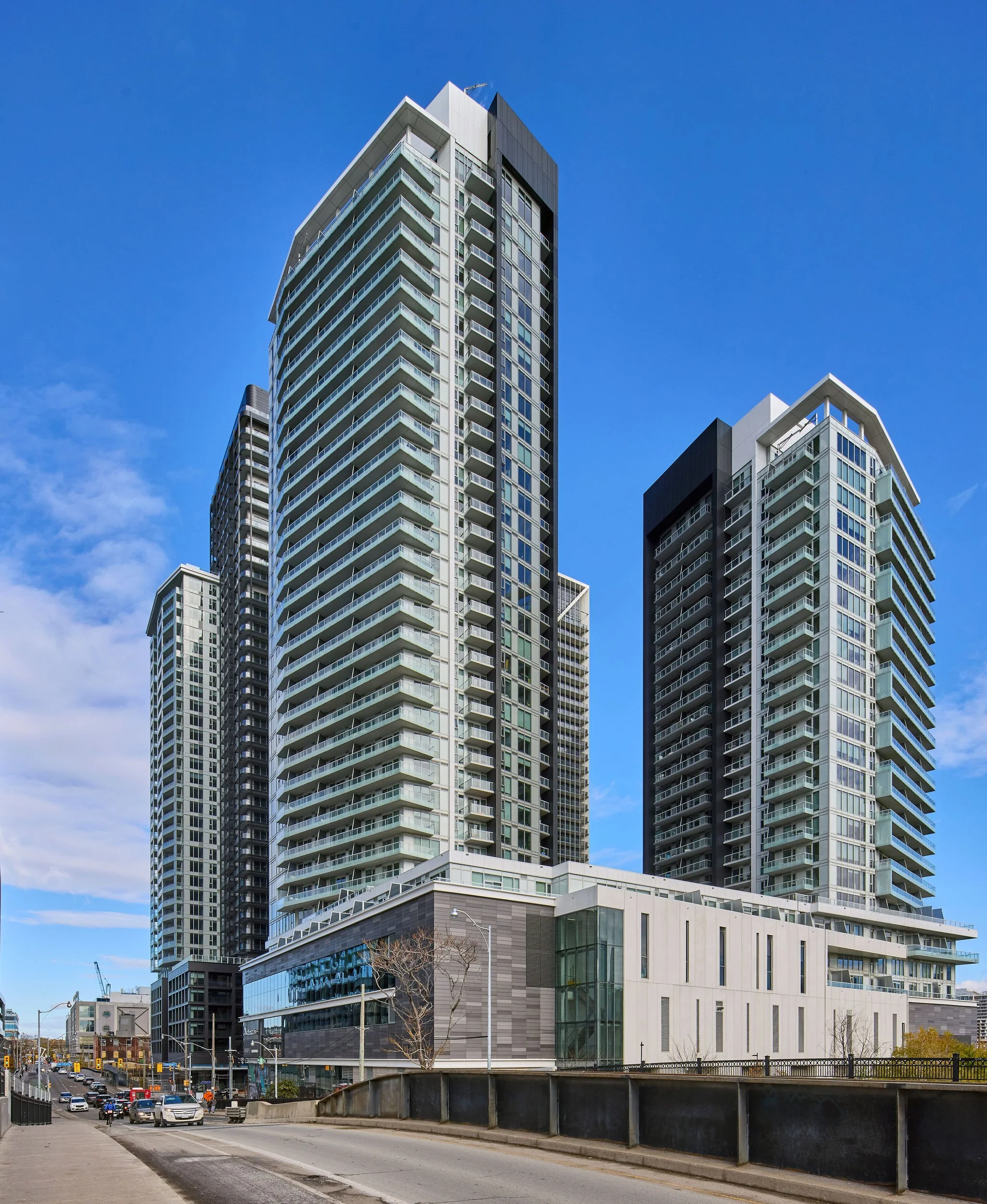 Modern high-rise residential and commercial buildings under a blue sky