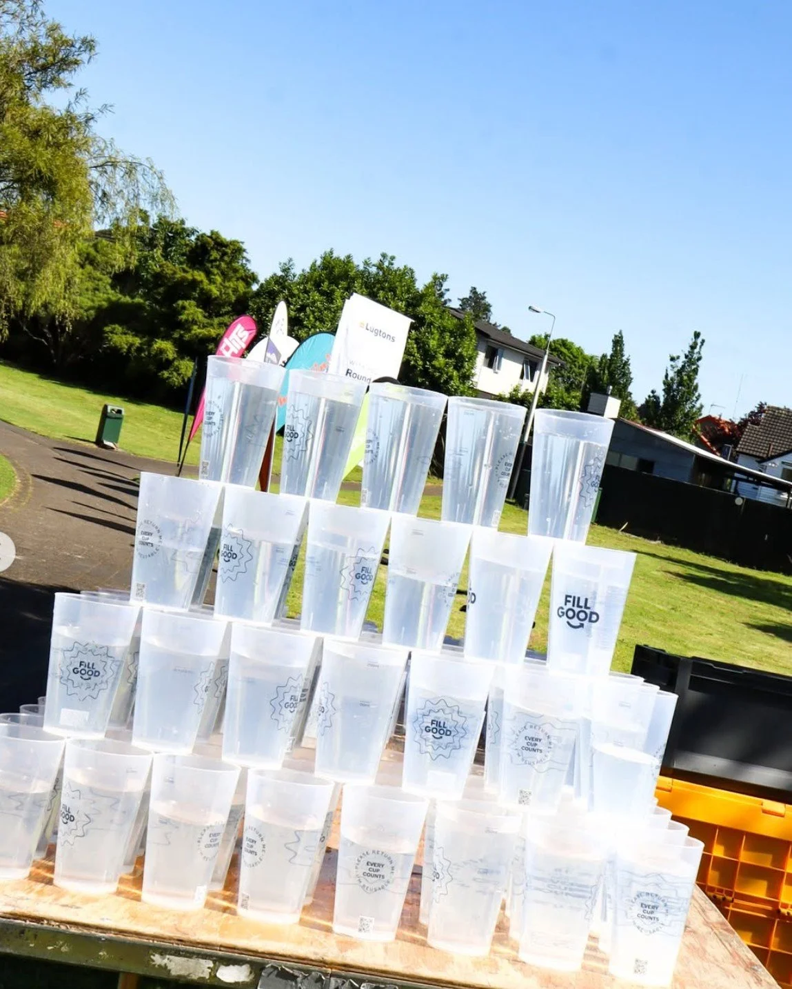 Fillgood reusable cups stacked in a pyramid on table waiting for runners at the event