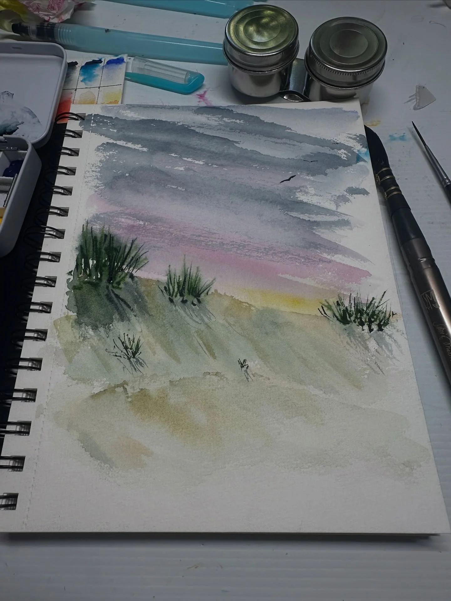 My desk this morning! I have a new sketchbook and a beautiful new travel brush so I couldn&rsquo;t wait to try them out. The sketchbook is a Windsor &amp; Newton a5 and I am going to fill it with landscapes. Travel sketching is on the agenda for 2026