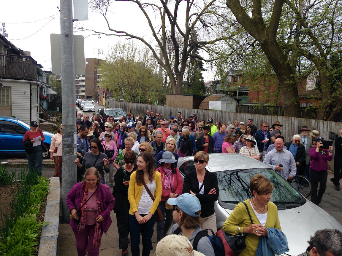 A big crowd out for a tour of the big trees and small houses of Craven Road in Toronto.