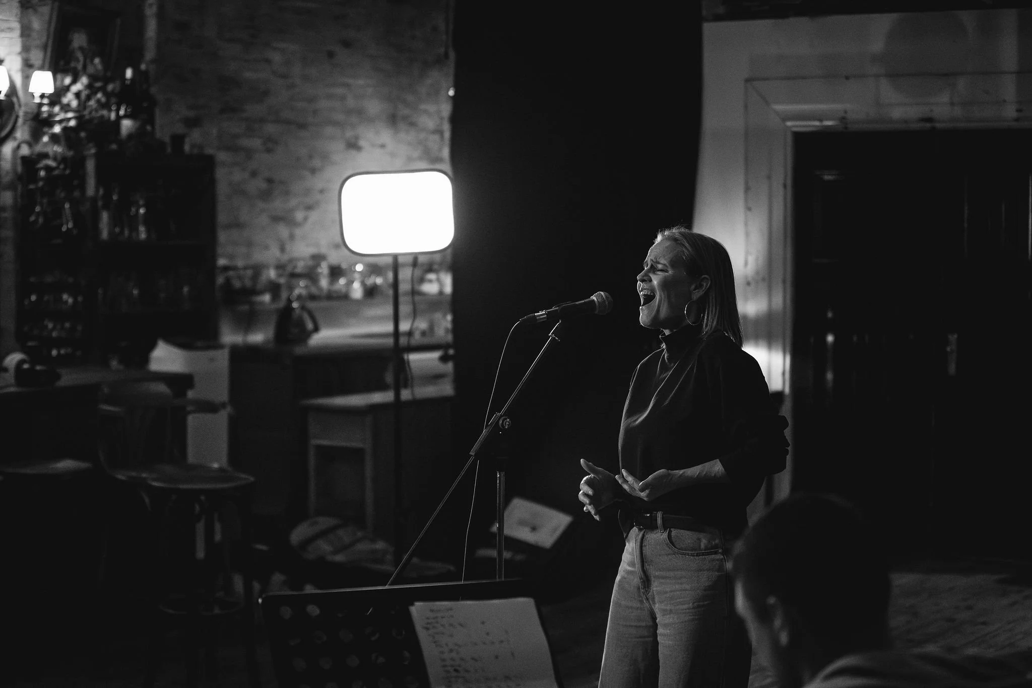 Shaynna Blaze performing her new single at studio microphone during music video shoot directed by Stef Hanson.