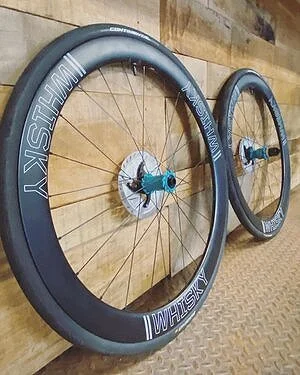 Two airplane wheels mounted on the wall, with the larger wheel in the foreground and a smaller one in the background.