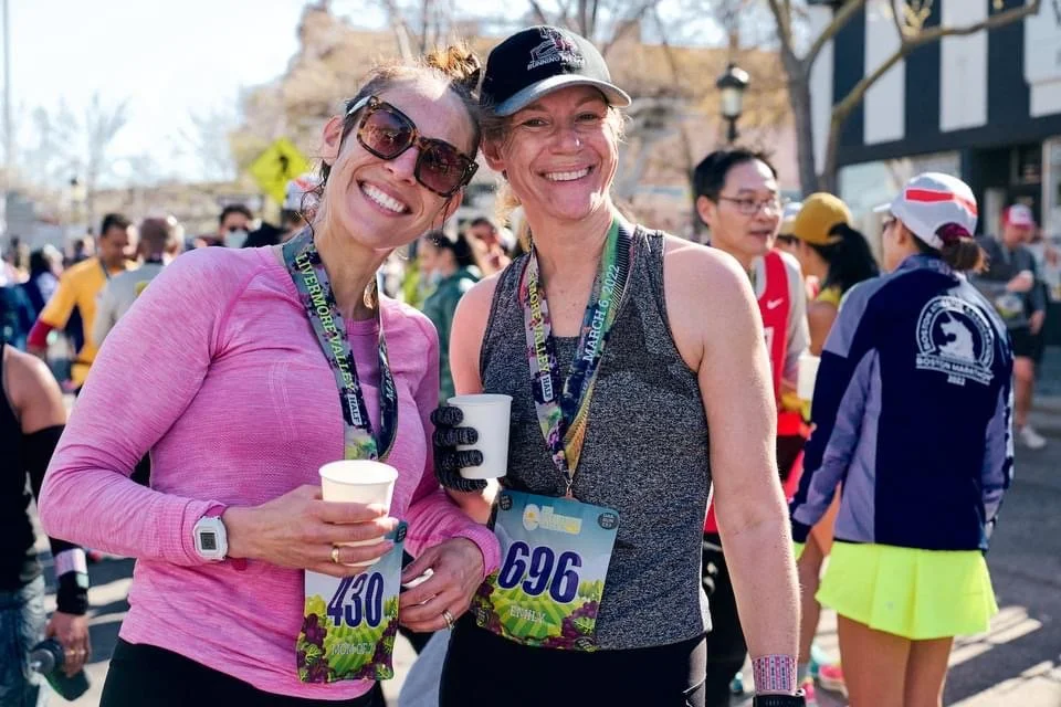 Running Fit Lab running team runners  with race bibs and medals smiling after a Livermore Valley Half Marathon