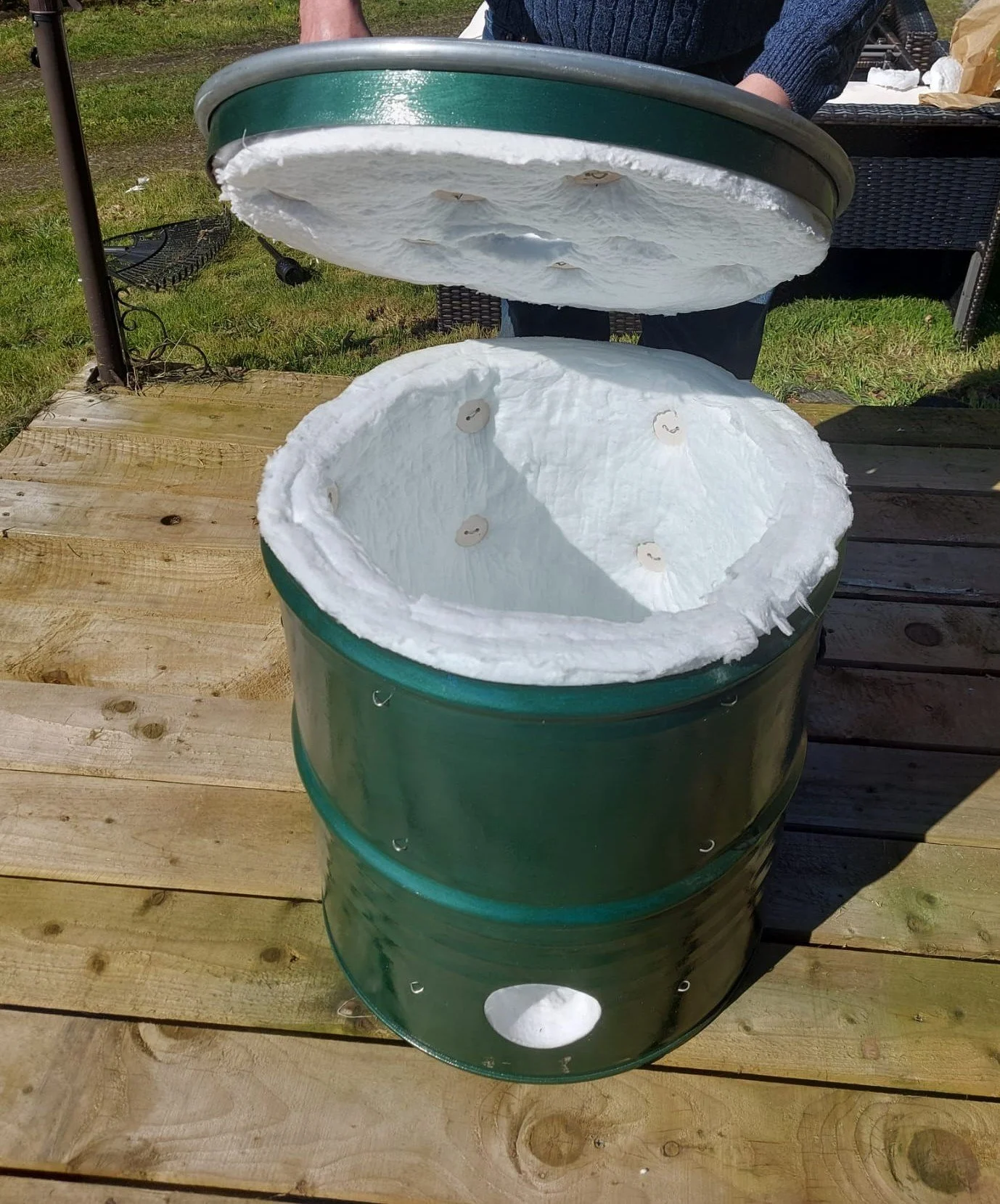 Raku kiln lifting off lid.jpg