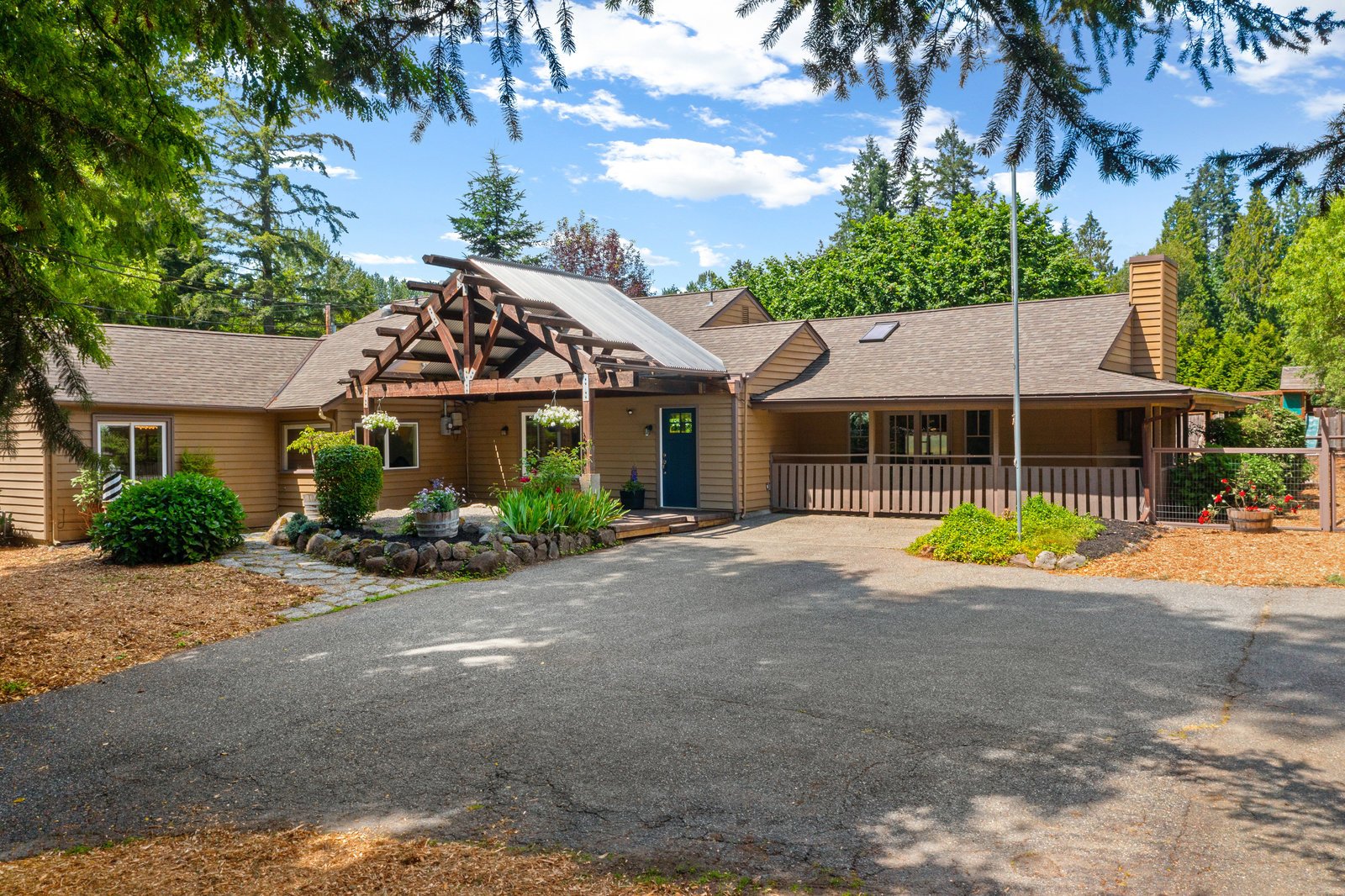 a brown country house with a large driveway