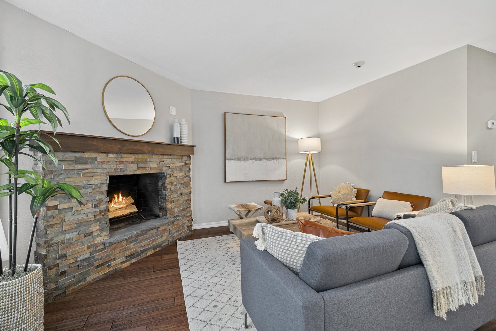 interior of living room with couch, chairs, fireplace and coffee table