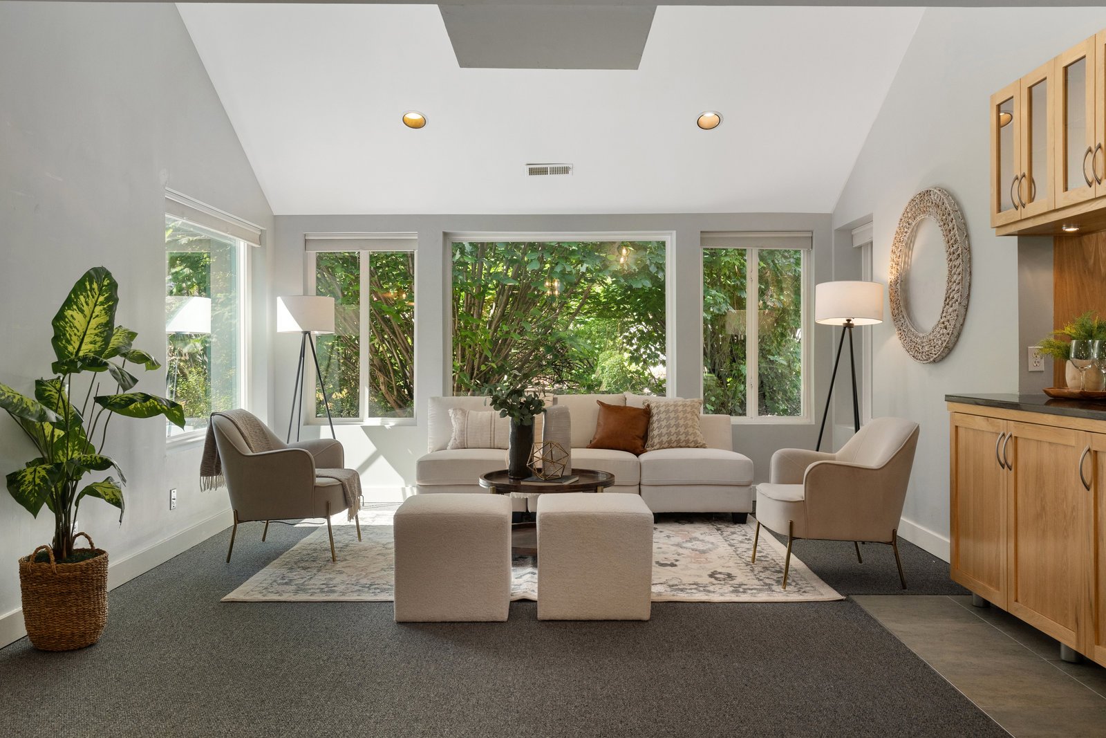 view of the living room in beige and white with expansive windows