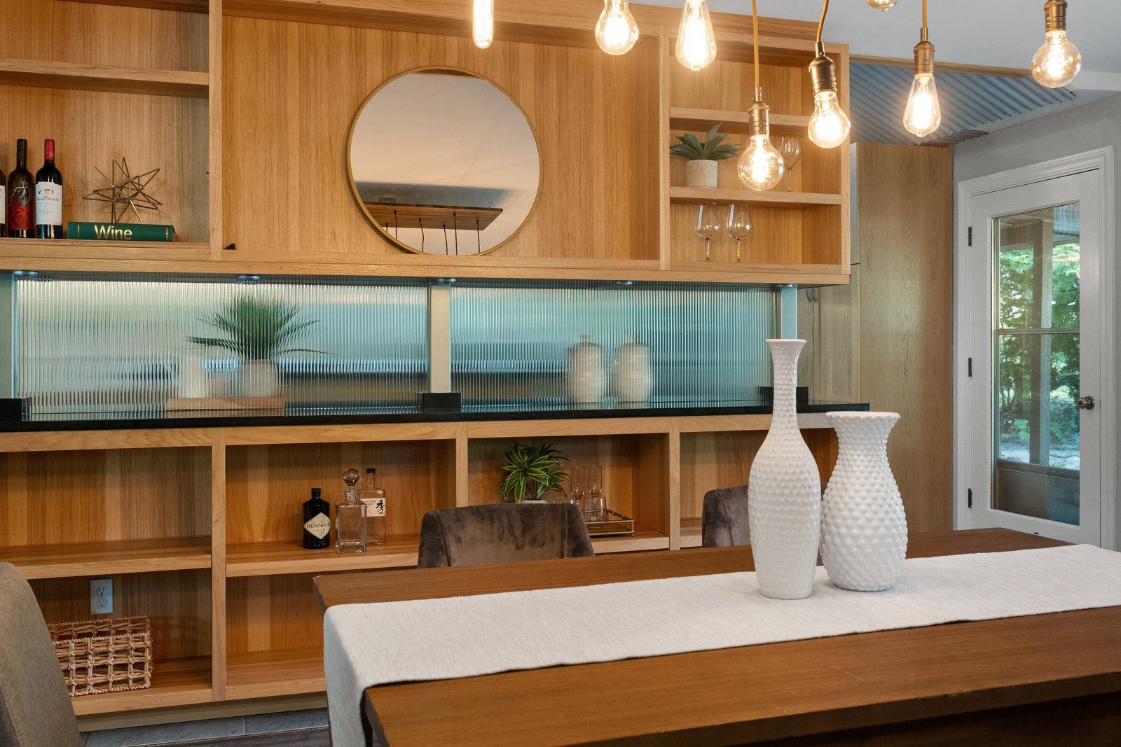 close up of the room separater in the dining room with white vases and plants