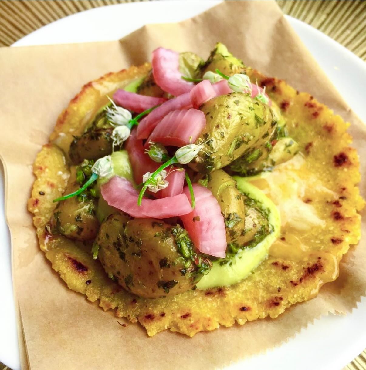 We make fresh heirloom tortillas for tacos, tostada bites, enchiladas, and crunchy salad toppers! This one is loaded with crispy potatoes, raw jack cheese, chimmichurri aioli, and pickled red onions 🩷🌮💕 #sandiegocatering #sandiegochef #taco #theti