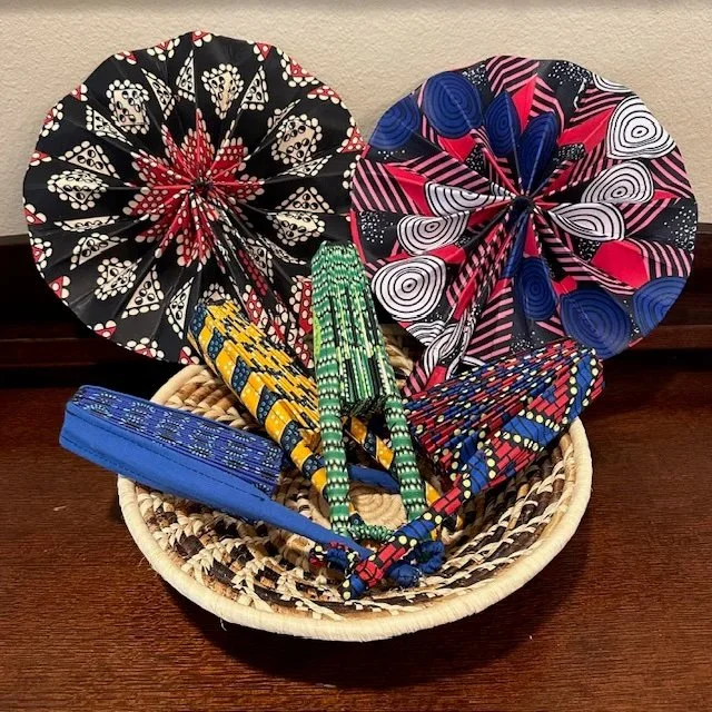 📣 New Product from Tabitha 
Artisans 📣
Cool off with these stylish handheld fans, beautifully covered in colorful fabric prints. Each fan contains a stretch-fabric clasp to keep the fan open or closed. Patterns and colors vary. Only $10 each.

👉  