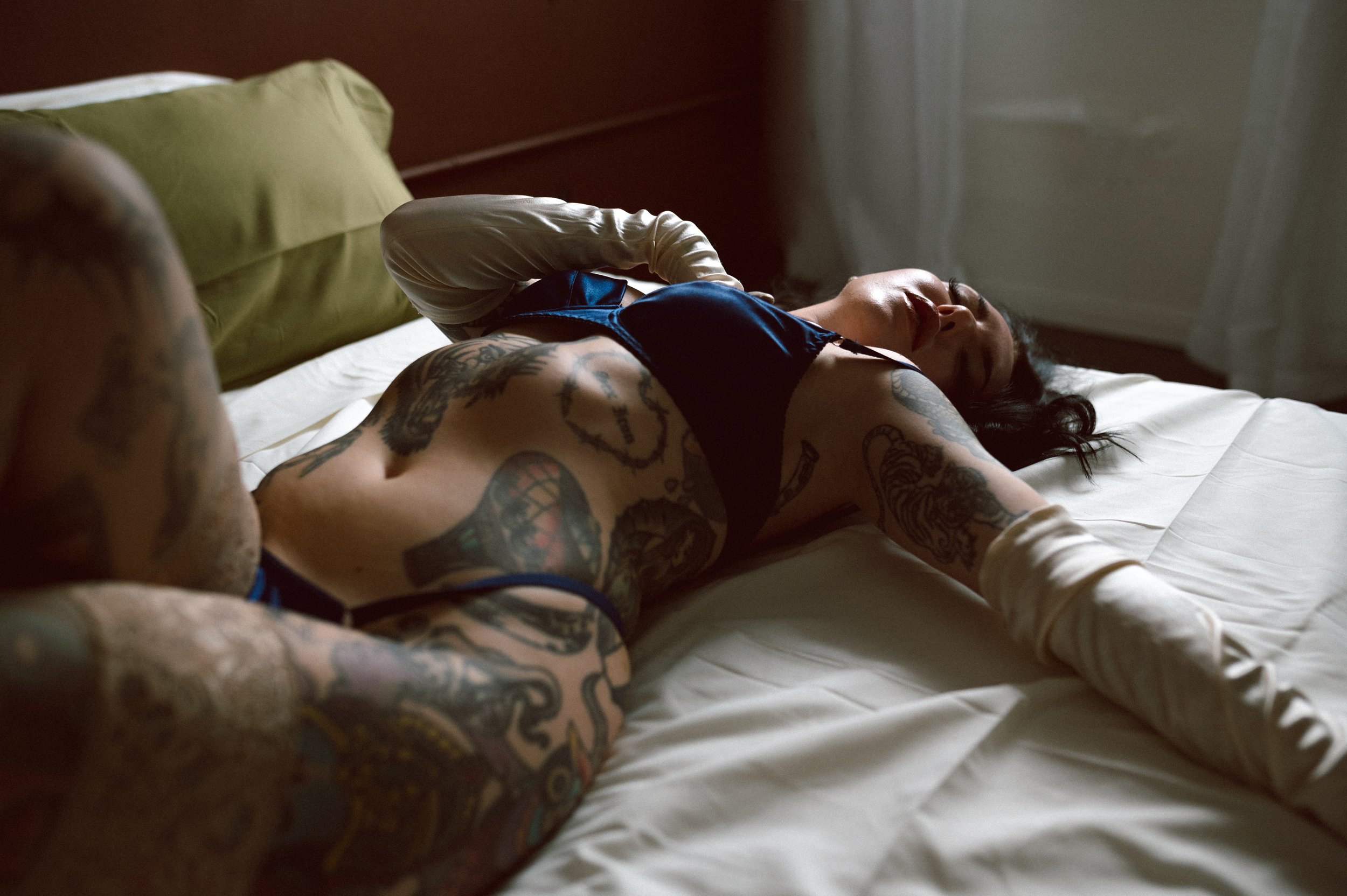 Las Vegas boudoir photographer studio portrait with dark moody lighting and feminine form
