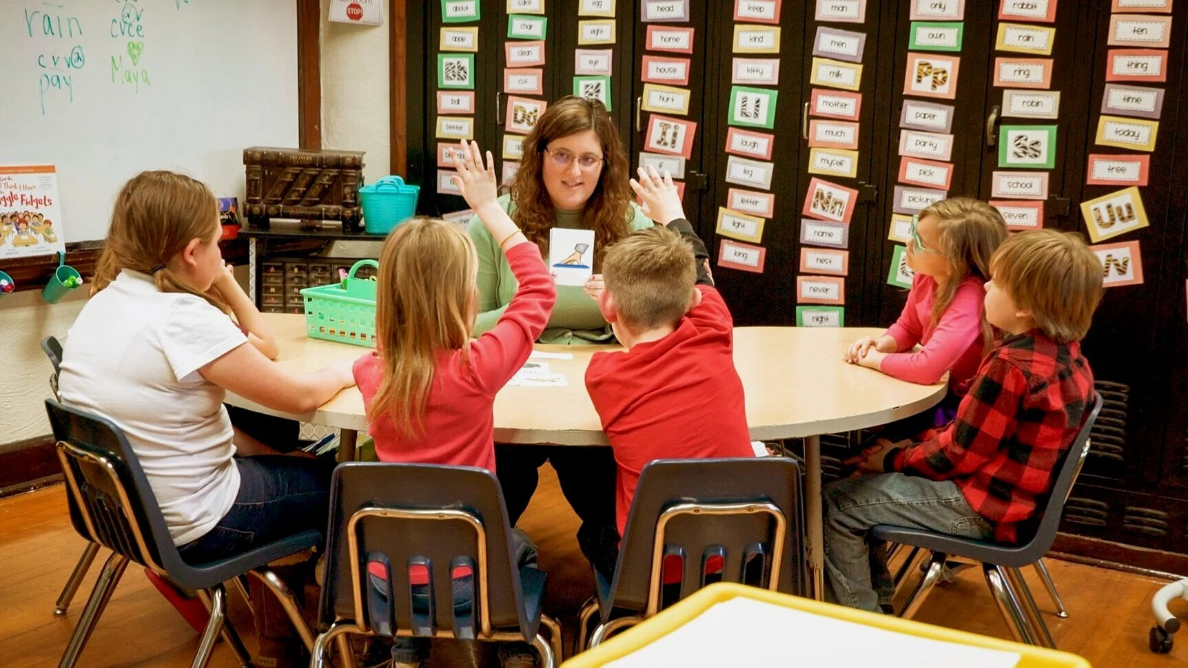 Teacher practicing flashcards with young students