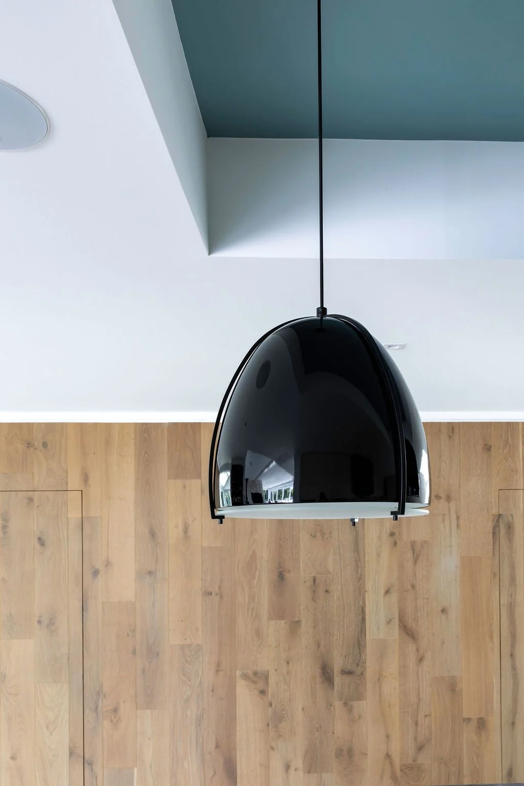 Architectural detail photography highlighting lighting design, ceiling geometry and wood finishes in a contemporary Connecticut residence.