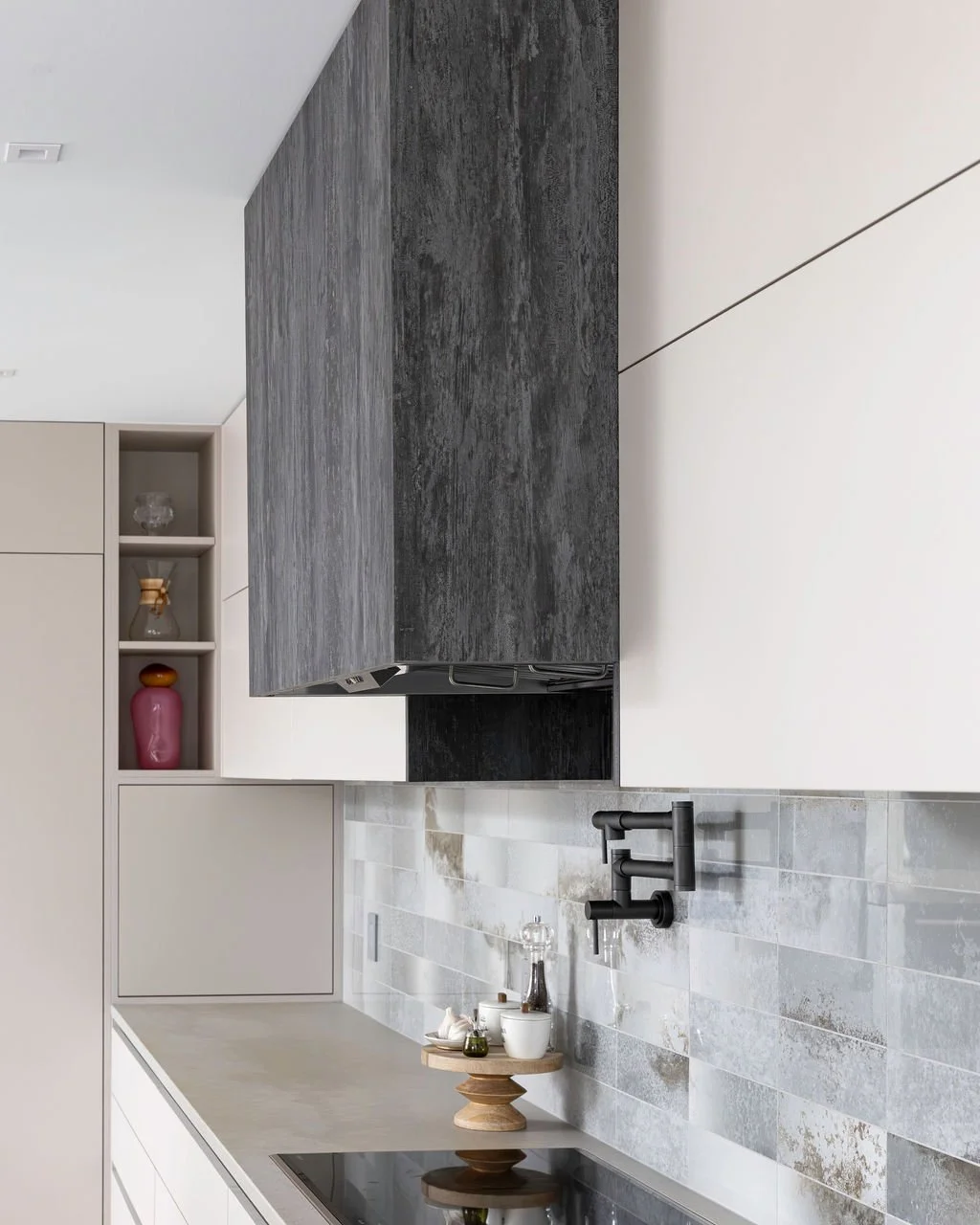 Custom cabinetry, range hood and backsplash details photographed to document the craftsmanship behind a finished kitchen project.