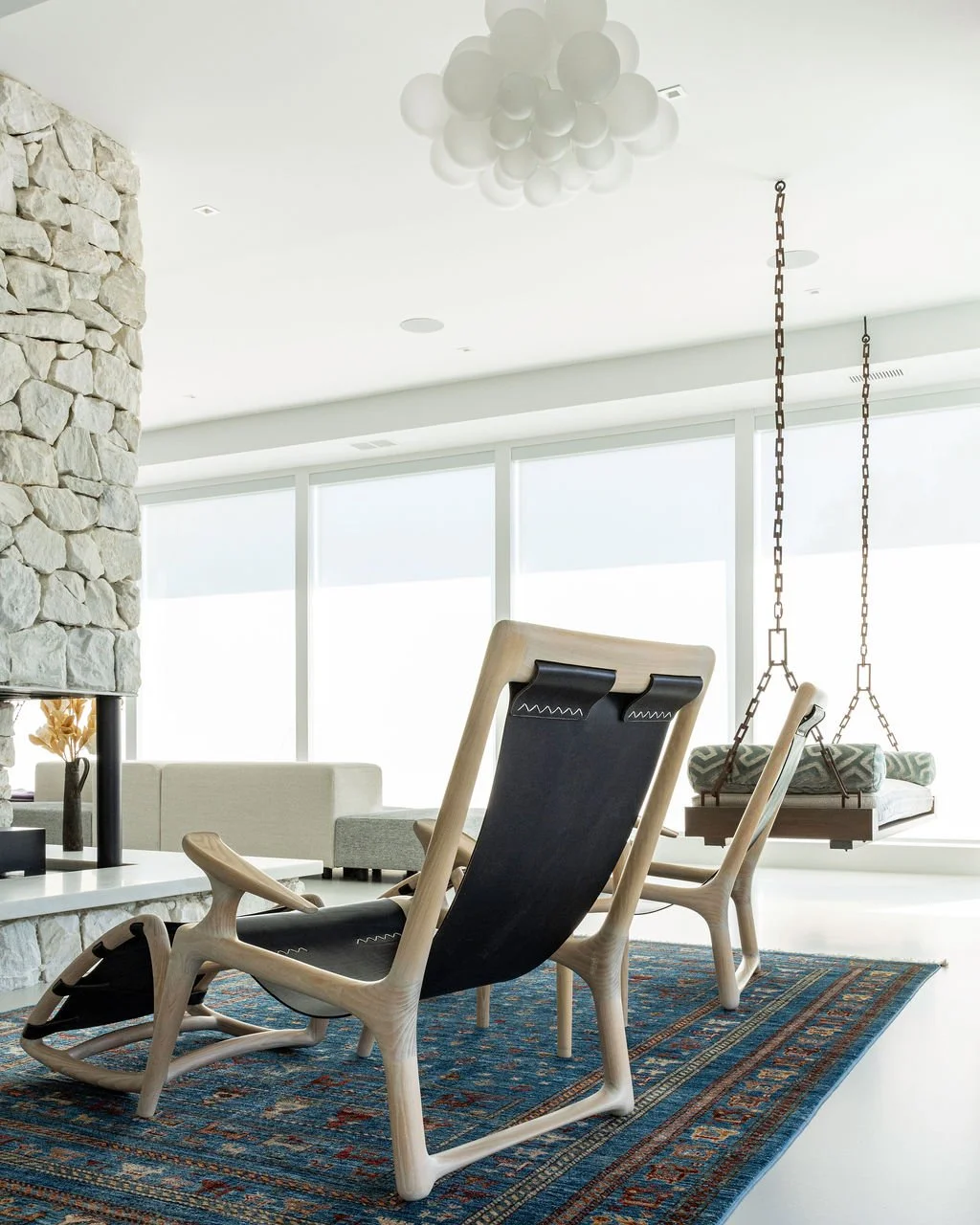 A layered interior view documenting custom furniture, stonework, textiles and architectural details within a contemporary Connecticut home.