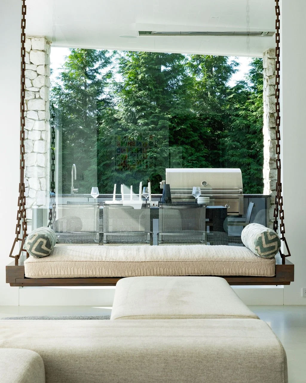 Distinctive architectural and furniture features deserve their own images—here, a custom suspended swing connects the interior with the outdoor living area.