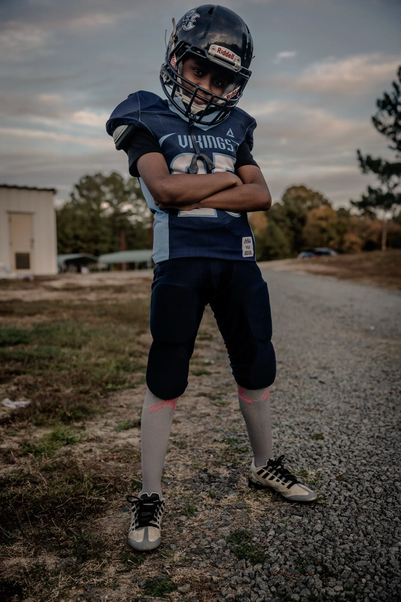 Youth football player portrait with dramatic sky — sports portrait — Universal Black Media Philadelphia