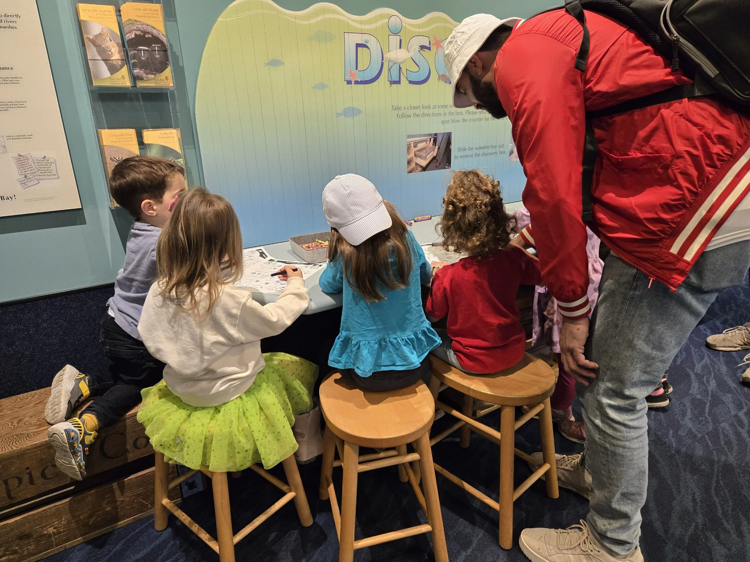 A parent supervises four children inside a visitor center at Crab Cove, Alameda.