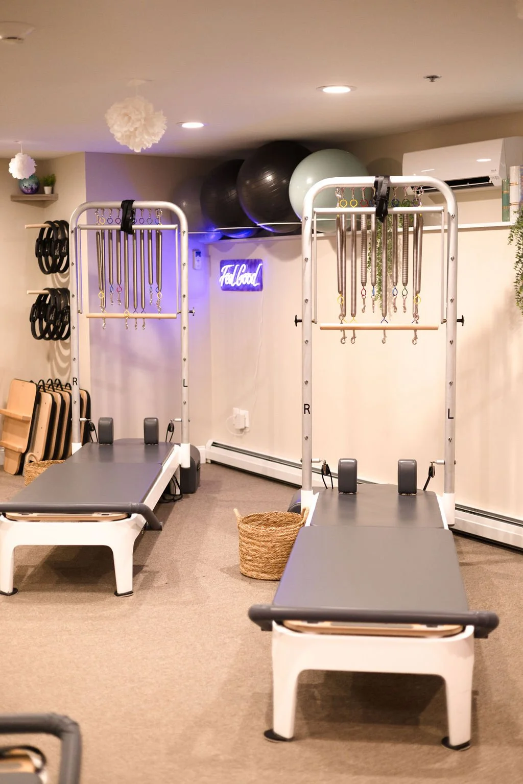 A modern house on a green hillside with snow-capped mountains in the background under a cloudy sky.