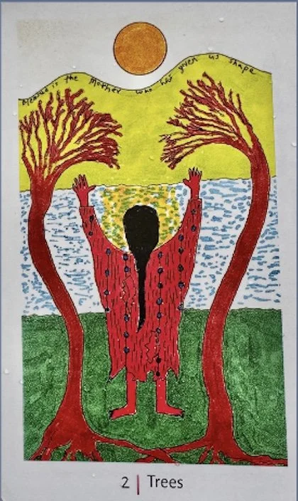 Woman facing the Sun with her arms outspread as if energy is entering her heart from the Sun, by her side are two trees drawn to the light of the Sun that appear to embrace her. In the foreground is a river, she stands on green grass