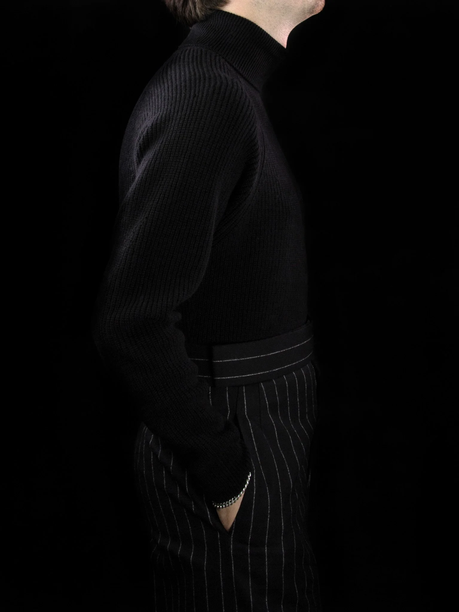 lawton-mens-english-rib-roll-neck-jumper-black-worn-side.jpg
