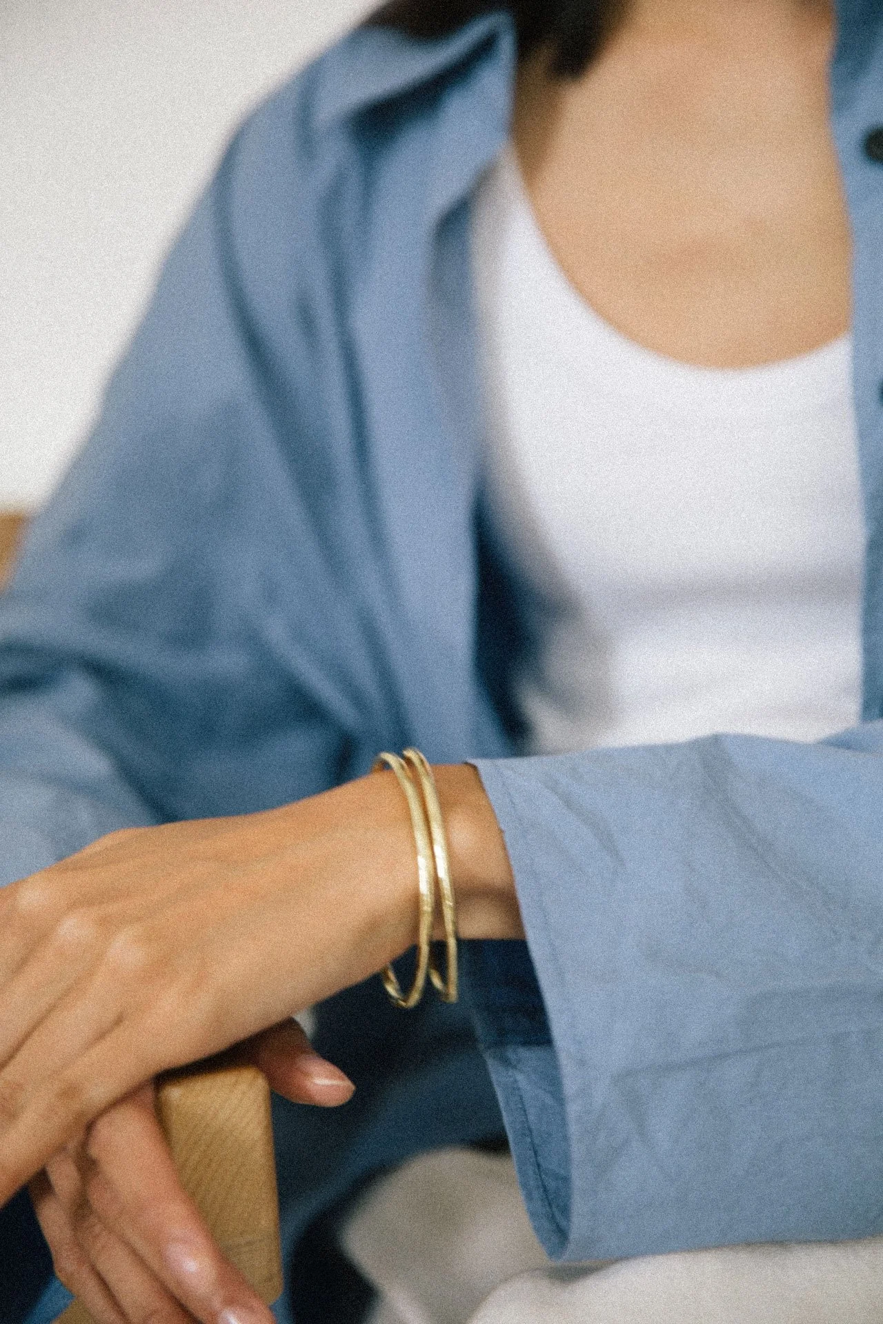 Aya in a seated pose, calm and contemplative, photographed for SE:COMMS