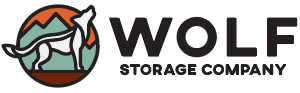 Wolf Storage Company logo featuring a stylized wolf and mountains.