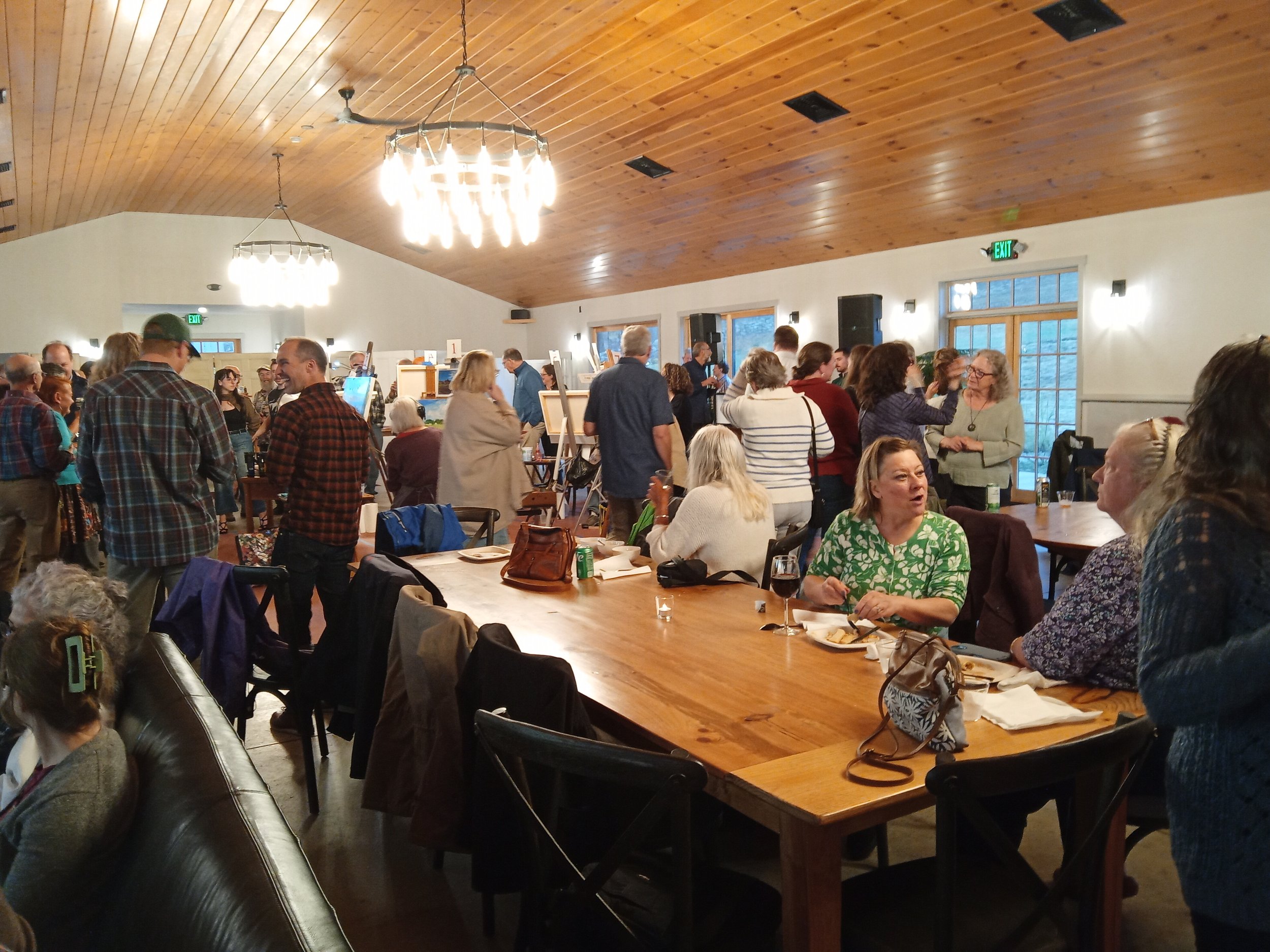 Image of a large room full of people mingling.