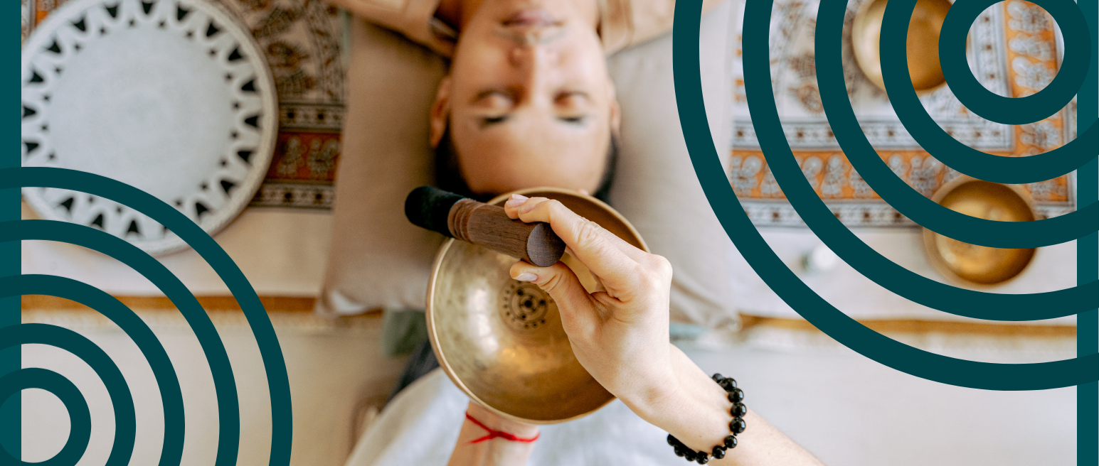 A woman receiving sound bowl therapy.